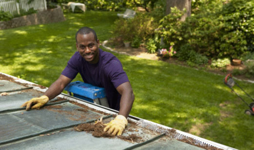 man cleaning gutters